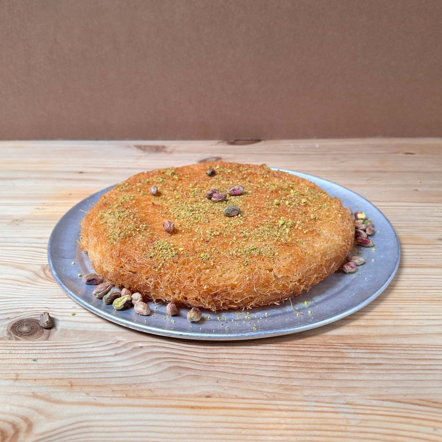 Delightful Kadaif Noodle Pastry filled with a mix of cheeses, topped with honey rose water syrup and crunchy pistachios