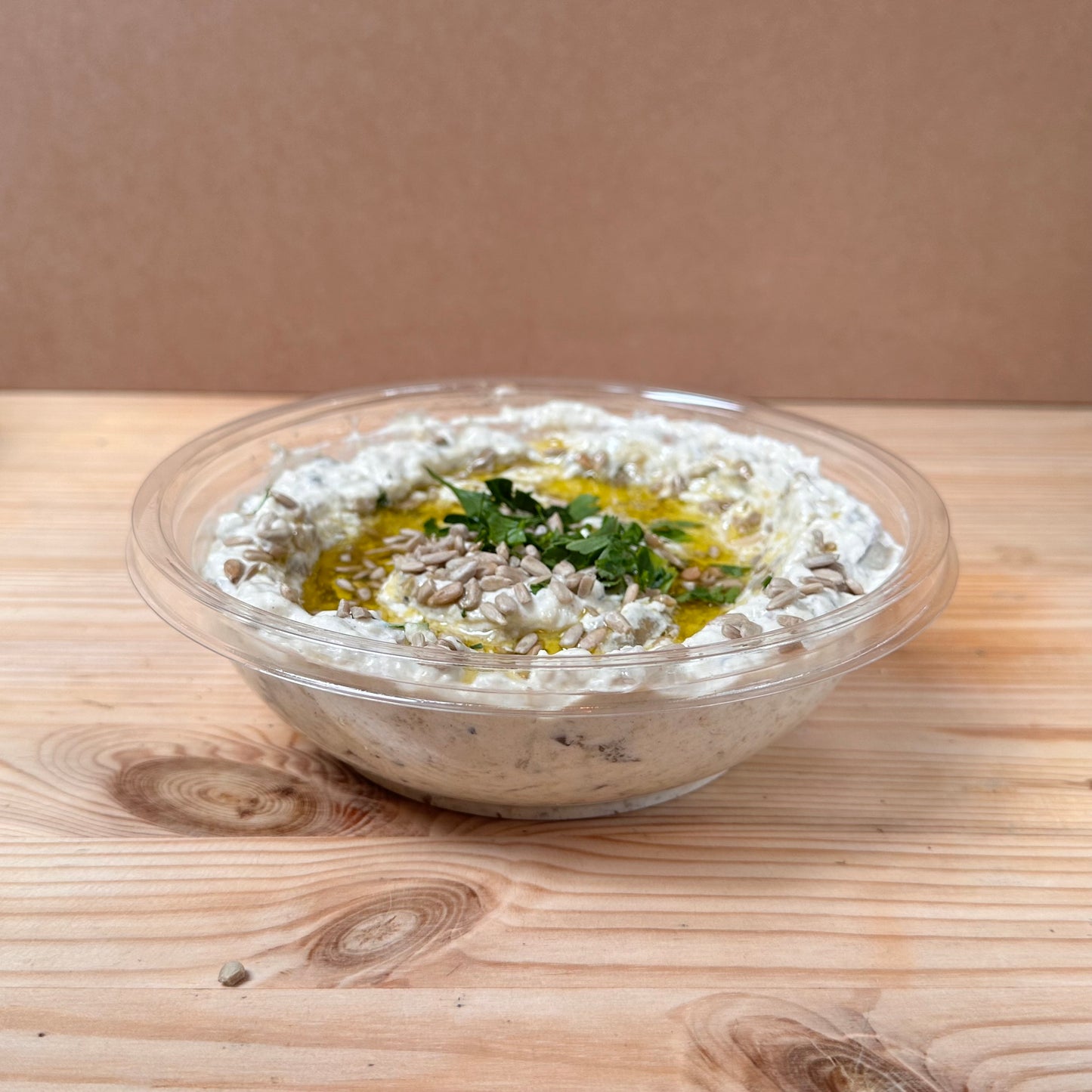 Chargrilled aubergines mixed with mayonnaise and garlic, topped with olive oil and sunflower seeds. 