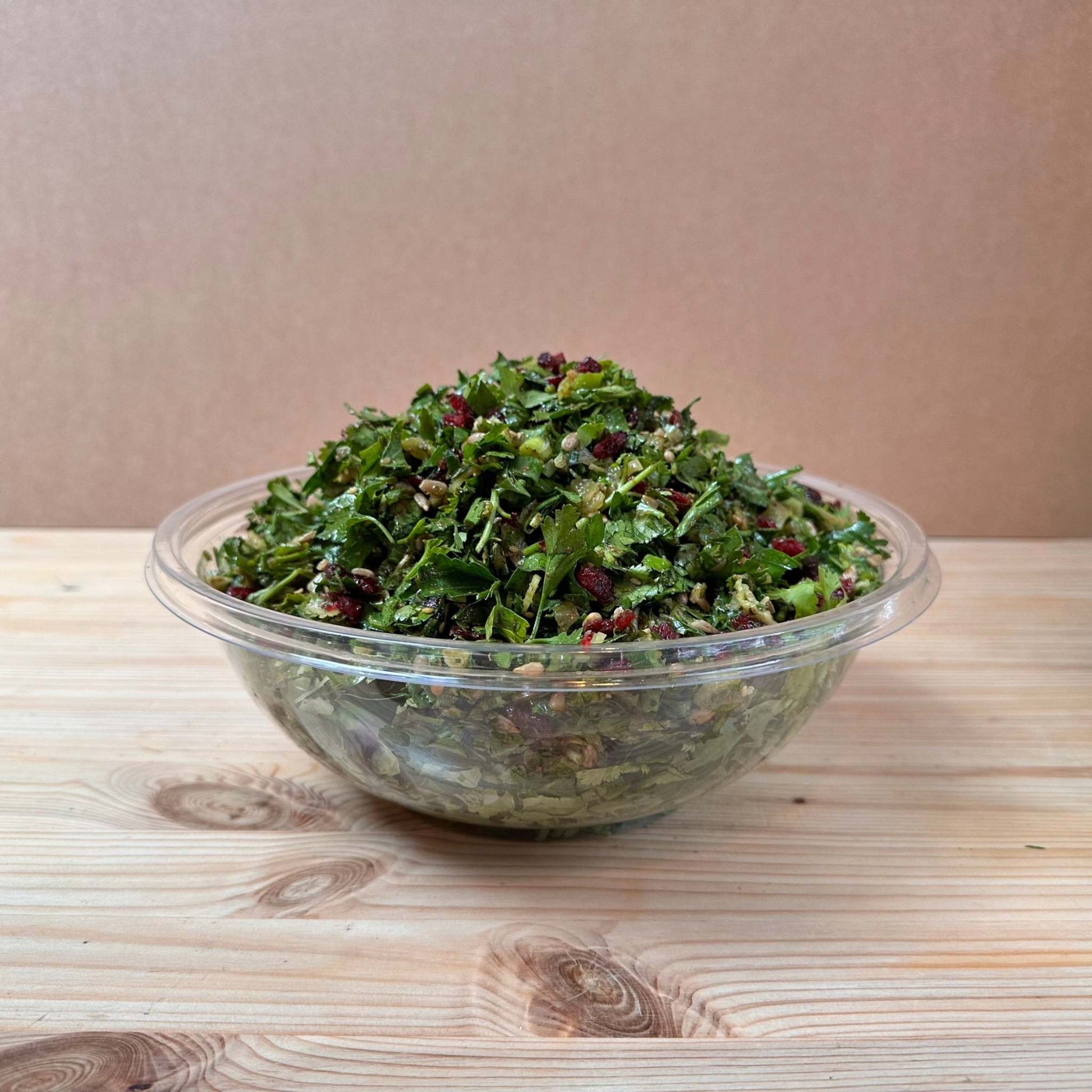 Fresh Herb Salad with finely chopped coriander, parsley, mint, celery, scallions, dried cranberries, and sunflower seeds, all dressed in a flavorful olive oil, za'atar, lemon, and sumac dressing.