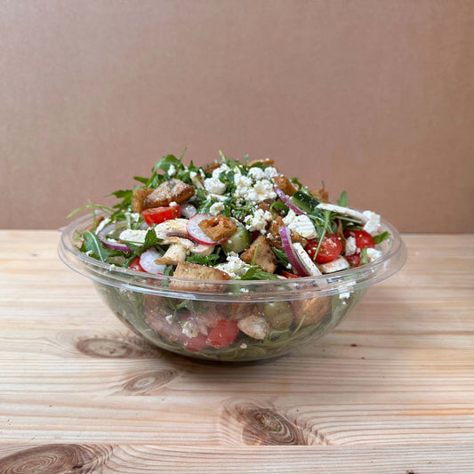 Fresh Garden Salad with lettuce, cucumber, cherry tomatoes, red onion, mushrooms, scallions, radish, olives, and parsley, dressed with sumac, za’atar, and olive oil, topped with Turkish cheese and crispy fried pita bits