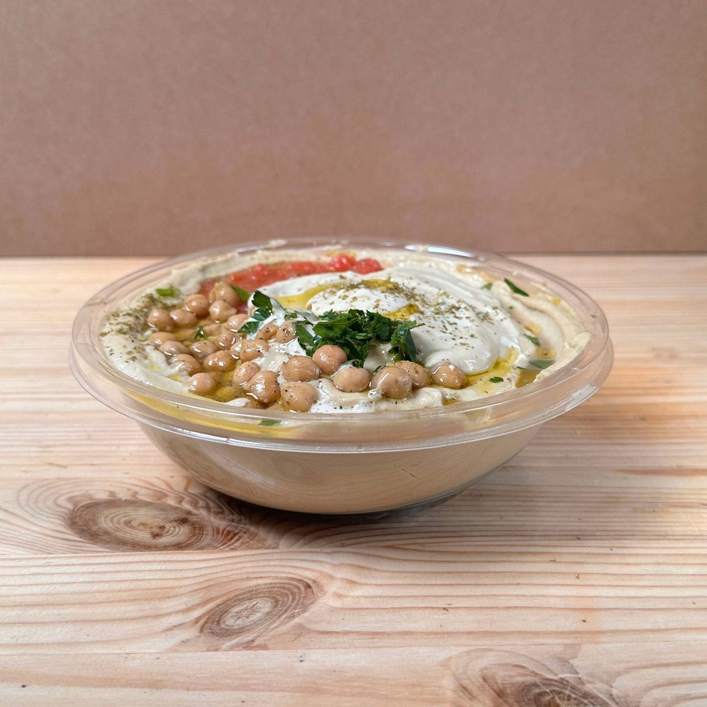 Our homemade original hummus, topped with tahini, olive oil, chickpeas, tomato salsa, za'atar and parsley.