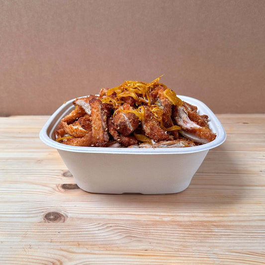 Crispy breaded fried chicken thigh, topped with grilled onions